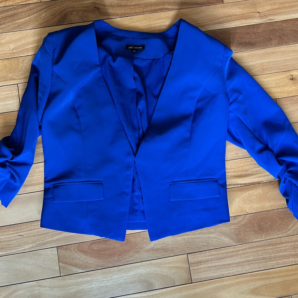 Short blue jacket with 3/4 ruched  sleeves.  Gently worn.  Size medium.